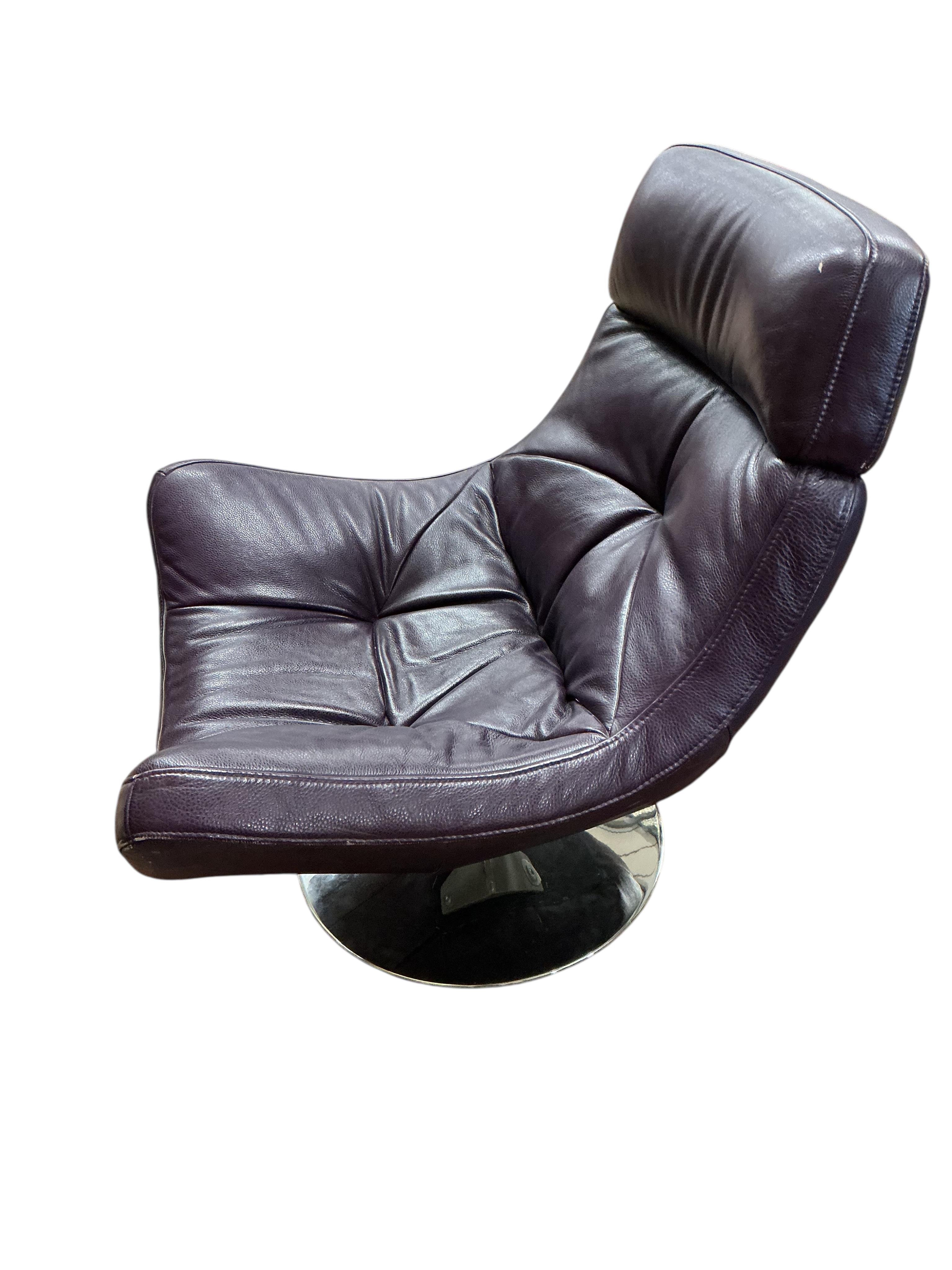 A Contemporary revolving recliner chair, upholstered in purple leather, width 82cm, depth 86cm, height 96cm